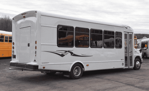 A white executive shuttle bus with side decals, perfect for group transport during the 2026 World Cup