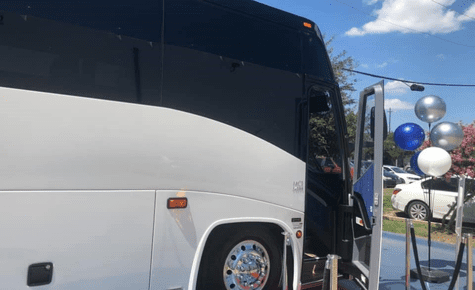 white luxury coach with an open door, decorated with balloons by dlbcs