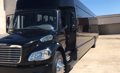 A long, sleek black luxury limo bus parked outdoors, designed for high-end group transportation to FIFA 2026 stadiums